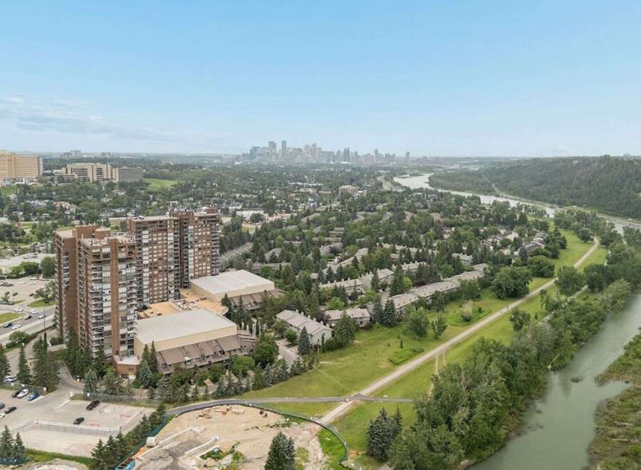 Experience breathtaking panoramic views from this stunning property, overlooking a serene river and a vibrant cityscape.