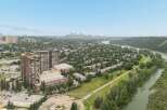 Experience breathtaking panoramic views from this stunning property, overlooking a serene river and a vibrant cityscape.
