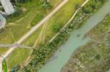 Discover this stunning aerial view showcasing a serene riverfront property, perfect for those seeking a blend of nature and accessibility.