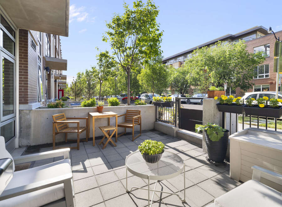 Enjoy outdoor living on this charming patio featuring comfortable seating and a dining set perfect for al fresco meals.