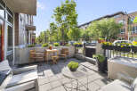 Enjoy outdoor living on this charming patio featuring comfortable seating and a dining set perfect for al fresco meals.