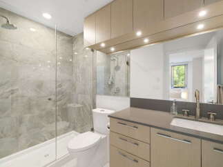 Experience modern luxury in this stunning bathroom featuring a spacious walk-in shower with elegant marble-look tiles and a sleek glass enclosure.