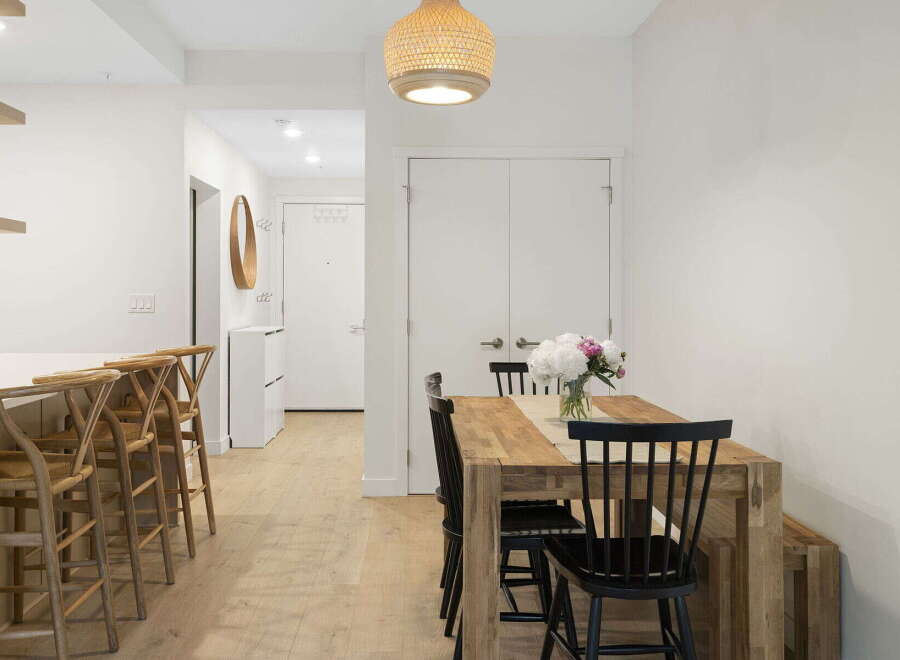 Experience modern living in this bright and airy dining area, featuring a stylish wooden dining table perfect for family meals and entertaining.