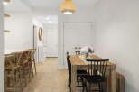 Experience modern living in this bright and airy dining area, featuring a stylish wooden dining table perfect for family meals and entertaining.
