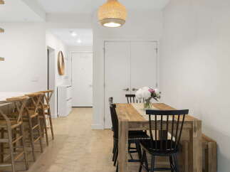 Experience modern living in this bright and airy dining area, featuring a stylish wooden dining table perfect for family meals and entertaining.