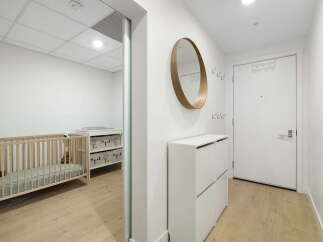 Welcome to this charming home featuring a bright and airy nursery with a crib and changing station, perfect for little ones.