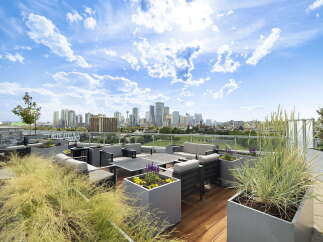 Experience luxury urban living with this stunning rooftop patio, offering breathtaking city skyline views.