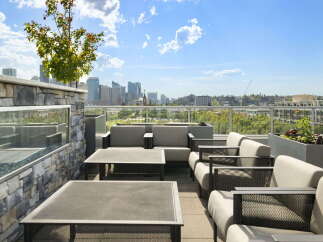 Experience breathtaking city views from this stunning rooftop patio, perfect for entertaining or relaxing.