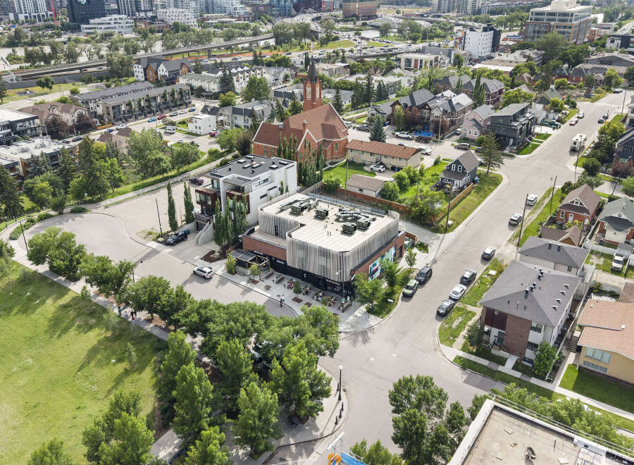 Discover modern living in this vibrant urban neighborhood, featuring contemporary townhouses and a stylish commercial building with outdoor seating.