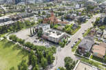 Discover modern living in this vibrant urban neighborhood, featuring contemporary townhouses and a stylish commercial building with outdoor seating.