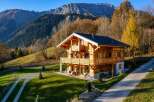 Experience the charm of this stunning wooden chalet nestled amidst the breathtaking autumn scenery of the Alps.