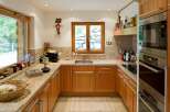 Discover this charming kitchen featuring warm wooden cabinetry and elegant granite countertops.