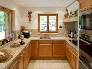 Discover this charming kitchen featuring warm wooden cabinetry and elegant granite countertops.