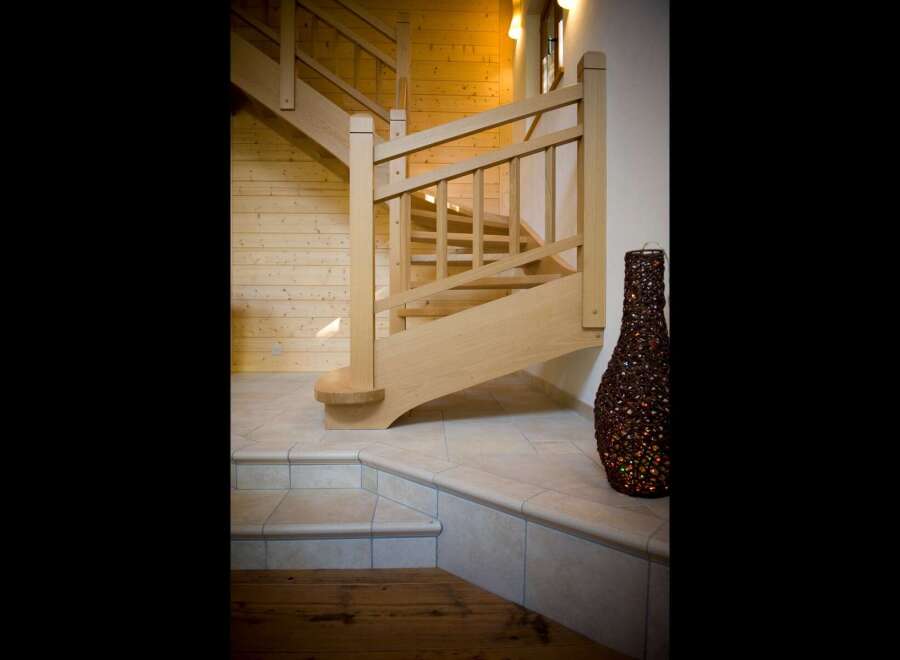 Ascend to the upper levels of this charming home via a beautifully crafted wooden staircase.