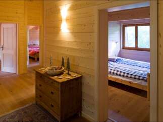 Experience rustic charm in this cozy wooden cabin, featuring two inviting bedrooms.