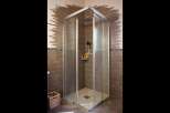 Experience modern luxury in this stunning bathroom featuring a spacious corner shower with frosted glass doors and a sleek chrome frame.