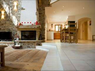 Experience rustic charm in this open-concept living space, featuring a magnificent stone fireplace as the centerpiece.