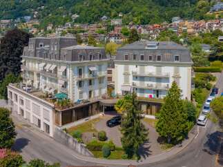 Discover this stunning property featuring elegant architecture and multiple balconies offering picturesque views.