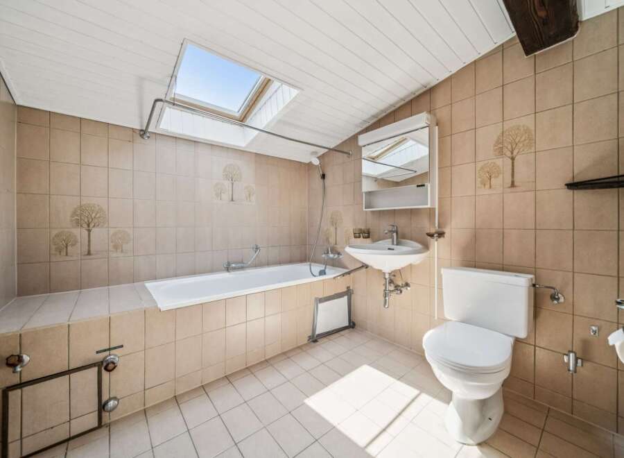 This charming bathroom features a spacious bathtub and a convenient sink, perfect for relaxation and daily routines.