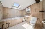 This charming bathroom features a spacious bathtub and a convenient sink, perfect for relaxation and daily routines.