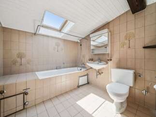 This charming bathroom features a spacious bathtub and a convenient sink, perfect for relaxation and daily routines.