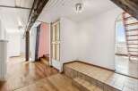 Discover this charming interior featuring exposed wooden beams and a bright, airy atmosphere.