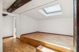 Discover this unique space featuring a raised wooden platform, perfect for a bedroom or lounge area.