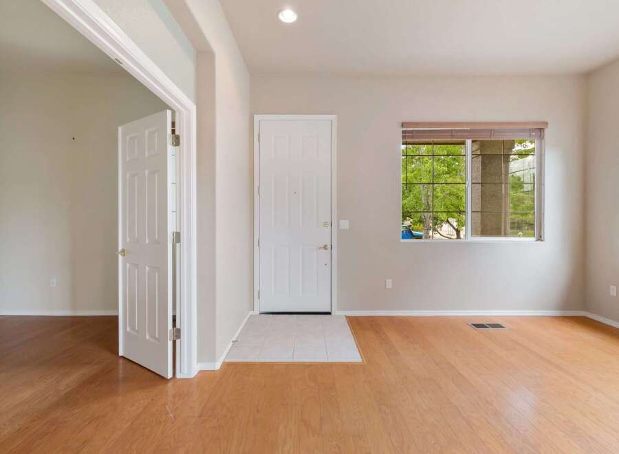 Step into this inviting entryway featuring a bright white front door and a convenient interior door leading to additional living space.