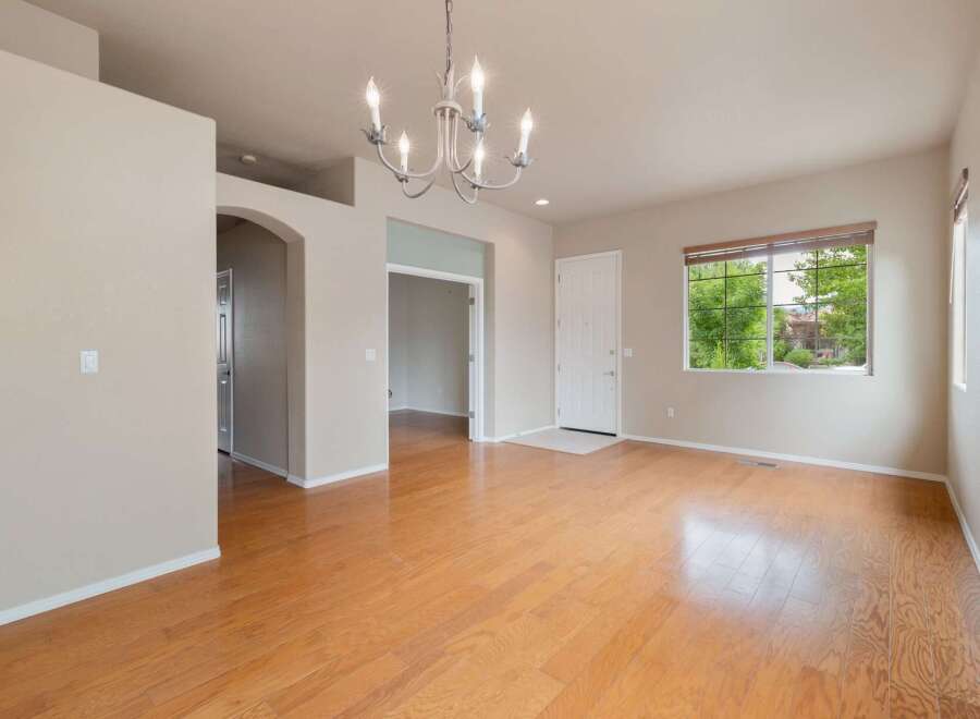 Step into this inviting living space featuring gleaming hardwood floors that extend throughout the home.
