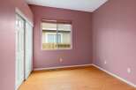 This charming room features a fresh coat of pink paint on its textured walls, creating a warm and inviting atmosphere.