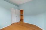 This room features a light blue painted wall and a polished hardwood floor, creating a bright and airy atmosphere.
