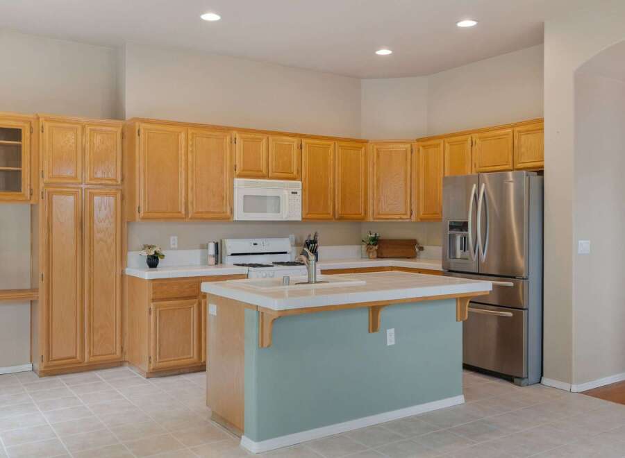 This spacious kitchen features ample natural light and a functional layout, perfect for any home chef.