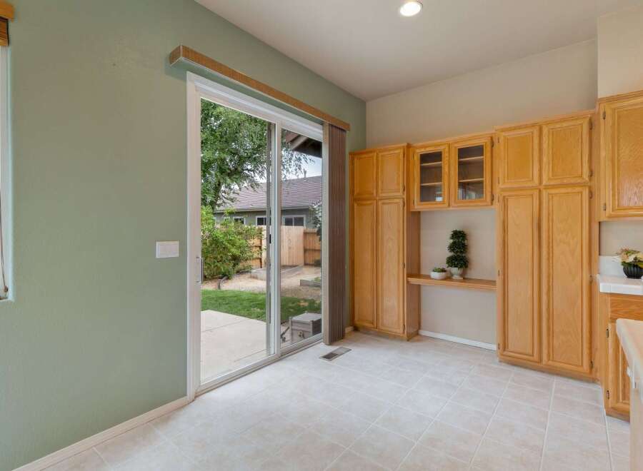 Step outside into your private backyard oasis through the spacious sliding glass doors, perfect for indoor-outdoor living.