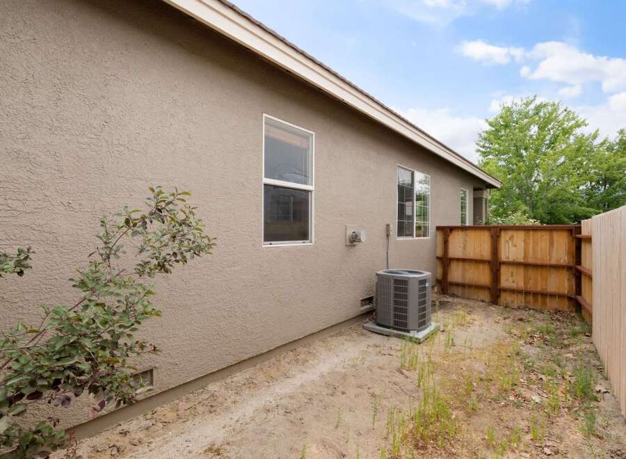 Discover this charming home featuring a neutral-toned stucco exterior and a durable roof.