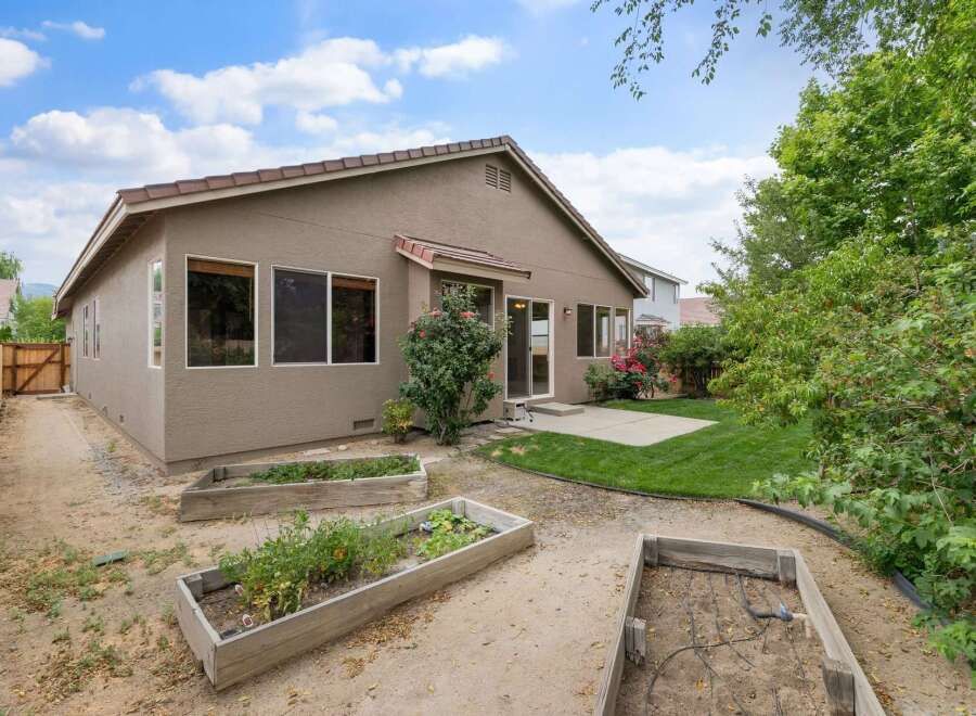 Discover a charming backyard oasis perfect for gardening enthusiasts.