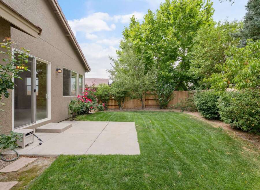 Enjoy outdoor living in this spacious backyard, featuring a well-maintained lawn perfect for recreation and relaxation.