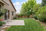 Enjoy outdoor living in this spacious backyard, featuring a well-maintained lawn perfect for recreation and relaxation.