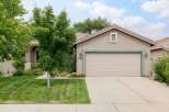 Discover this charming single-family home featuring a well-maintained lawn and mature trees, offering a welcoming curb appeal.