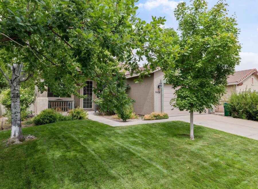 Discover this charming home featuring a well-maintained lawn and mature trees, perfect for outdoor enjoyment.