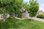 Discover this charming home featuring a well-maintained lawn and mature trees, perfect for outdoor enjoyment.