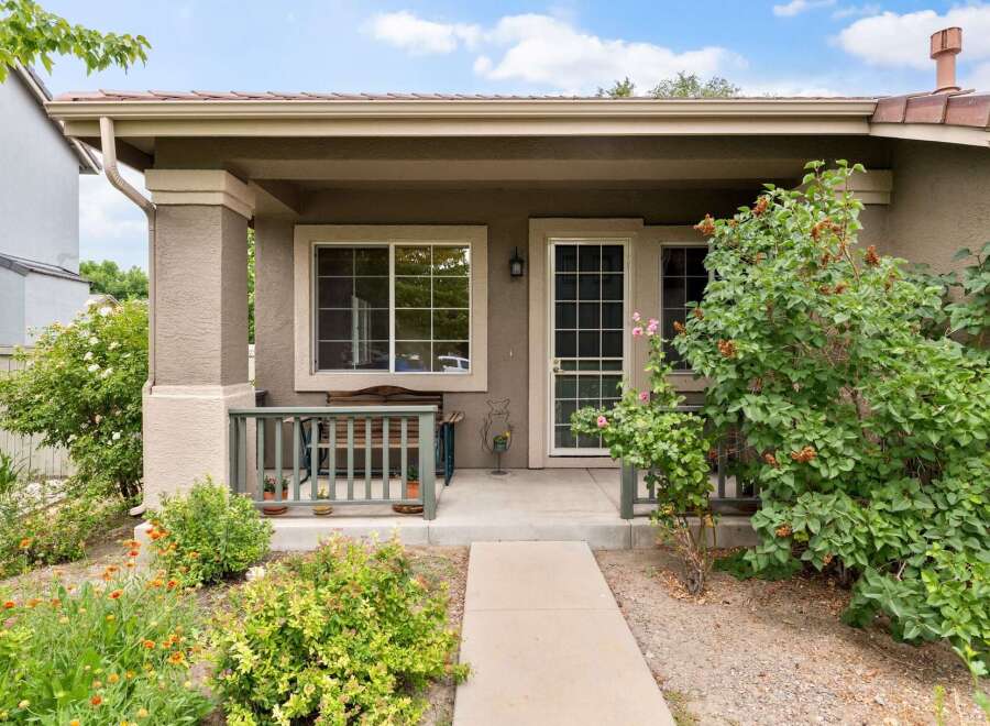 Charming front porch with a wooden bench and railing, perfect for enjoying the outdoors.