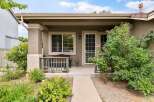 Charming front porch with a wooden bench and railing, perfect for enjoying the outdoors.