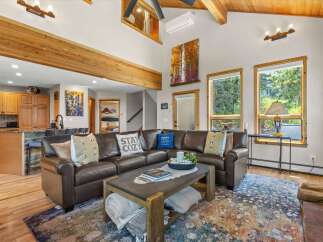 Experience ultimate comfort in this spacious living room, featuring a luxurious leather sectional sofa perfect for cozy gatherings.