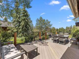 Enjoy breathtaking mountain views from this expansive deck, perfect for outdoor entertaining.