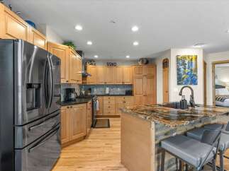 Experience the heart of this home with a stunning kitchen featuring a large granite island, perfect for entertaining.