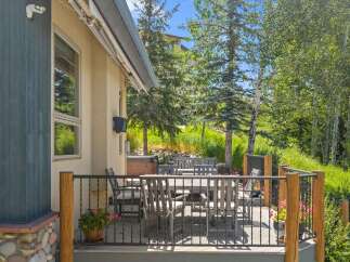 Enjoy outdoor living on this spacious deck, complete with a dining set perfect for al fresco meals.