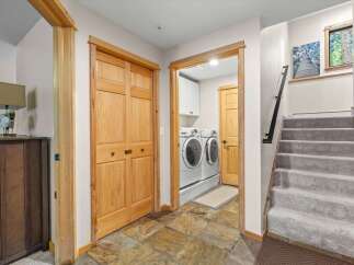 Discover a functional and stylish entryway featuring a convenient laundry room with modern appliances and ample storage.