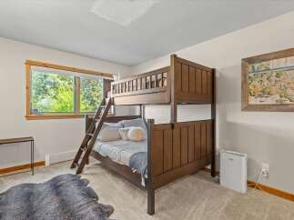 This charming bedroom features a sturdy wooden bunk bed, perfect for accommodating guests or family.