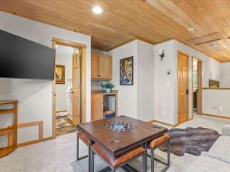 This inviting living space features a large flat-screen TV mounted on the wall, perfect for entertainment.