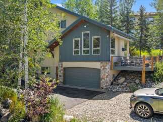 Discover this stunning mountain home featuring a spacious deck perfect for outdoor entertaining and enjoying scenic views.